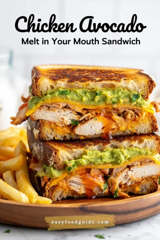 Close-up of a delicious Chicken Avocado Melt Sandwich with chicken, avocado, and melted cheese, served with crispy fries.