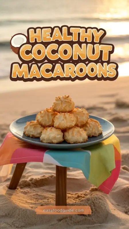 A plate of coconut macaroons on a colorful tablecloth by the beach, with palm trees and a surfboard in the background.