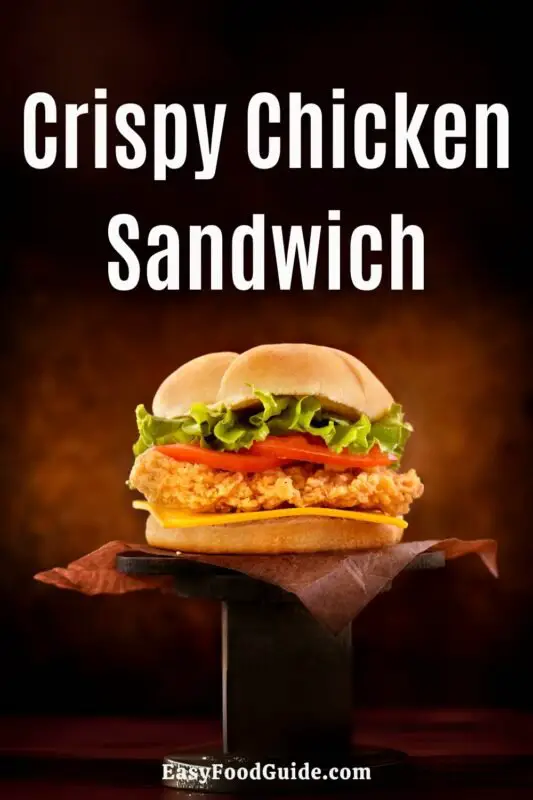 Crispy chicken sandwich with lettuce, tomato, pickles, and special sauce on a brioche bun, served with fries.