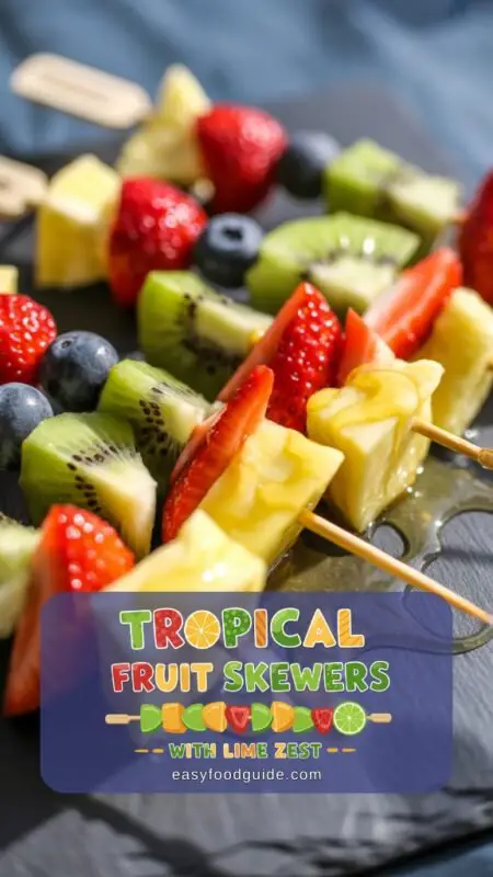 Colorful tropical fruit skewers on a wooden platter surrounded by vibrant green leaves and flowers.