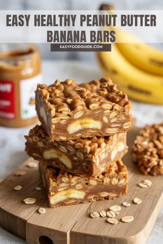A stack of Peanut Butter Banana Oatmeal Bars on a wooden board with a jar of peanut butter and ripe bananas in the background.