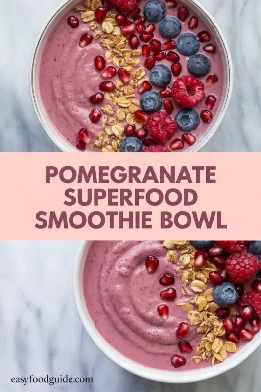 A vibrant pomegranate smoothie bowl topped with granola, chia seeds, and fresh pomegranate seeds, set on a rustic wooden table.