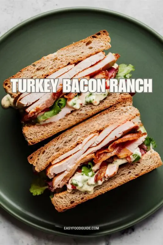 Turkey bacon ranch sandwich with turkey, bacon, vegetables, and ranch dressing on whole wheat bread.