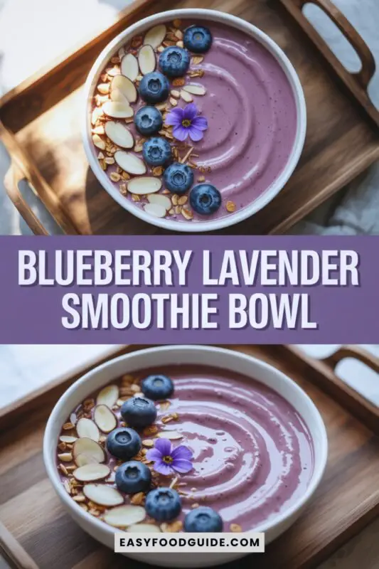 blueberry-lavender-smoothie-2 A vibrant blueberry lavender smoothie bowl topped with blueberries, almond slices, and edible flowers on a wooden tray.