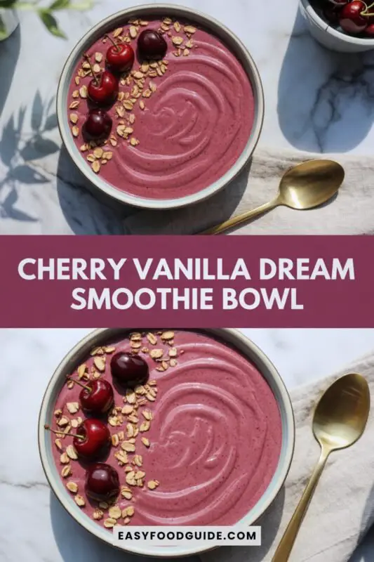 cherry-vanilla-smoothie-1 A colorful Cherry Vanilla Smoothie Bowl topped with fresh cherries and granola on a wooden table.