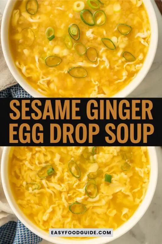 egg-drop-soup-1 A bowl of Sesame Ginger Egg Drop Soup with egg ribbons and scallions, garnished with sesame seeds on a rustic table.