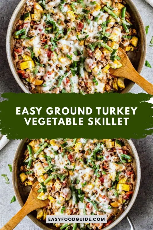 A hearty ground turkey vegetable skillet with melted mozzarella cheese, featuring zucchini, summer squash, and green beans, on a rustic wooden table.