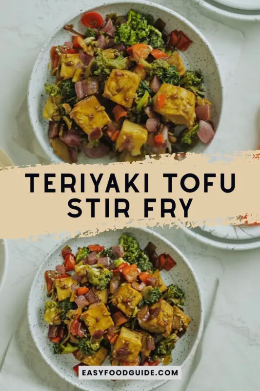 A vibrant Teriyaki Tofu Stir Fry with tofu, broccoli, bell peppers, and carrots on a plate with rice.