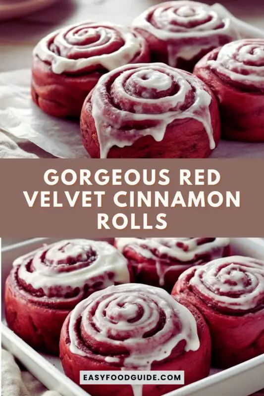 Freshly baked red velvet cinnamon rolls topped with cream cheese frosting on a rustic wooden table.