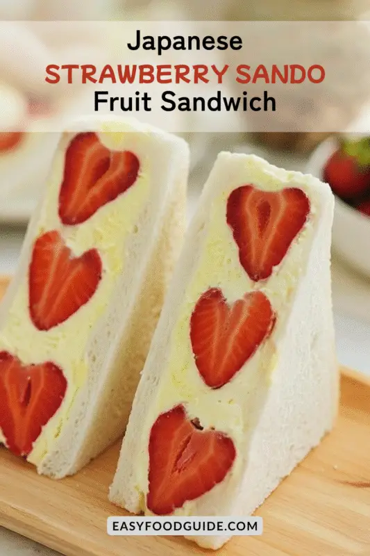 A beautifully cut Japanese Strawberry Sando with strawberries and whipped cream in soft white bread, presented on a blurred background.