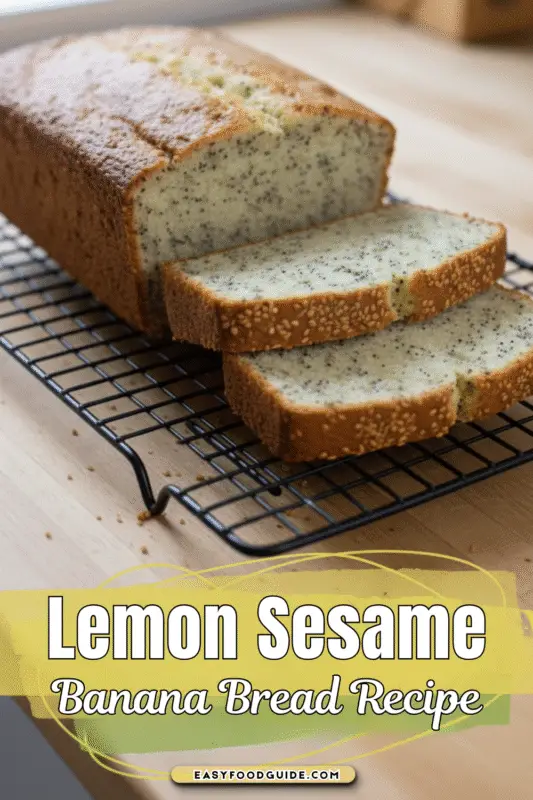 Sliced lemon sesame banana bread on a wooden board, garnished with lemon zest and sesame seeds.