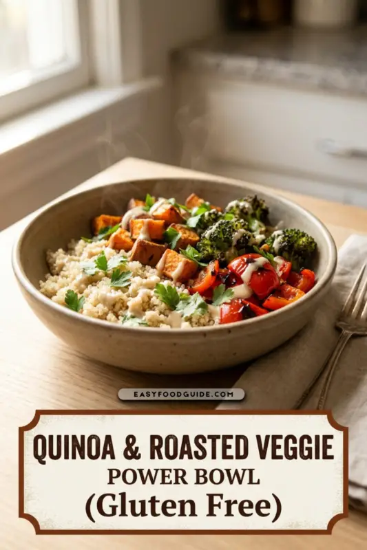 A colorful quinoa and roasted veggie power bowl with broccoli, sweet potatoes, bell peppers, and tahini dressing.
