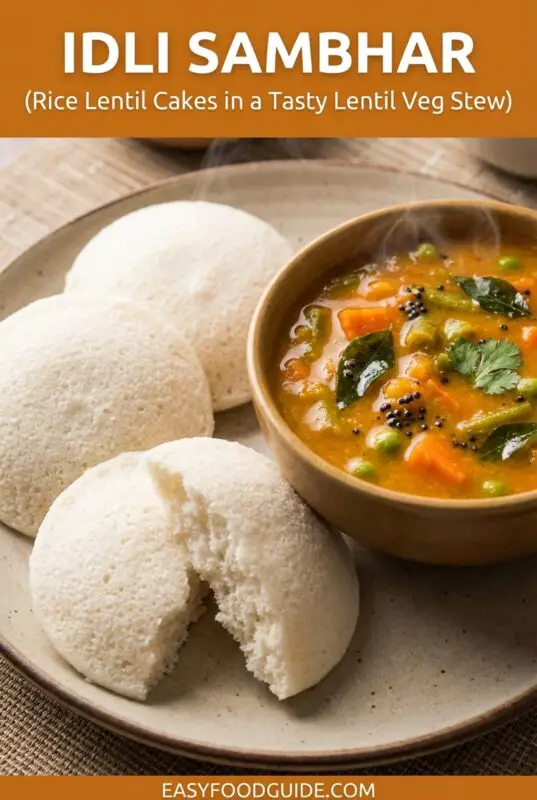 Fluffy idlis served with sambar, garnished with coriander, on a traditional Indian plate.