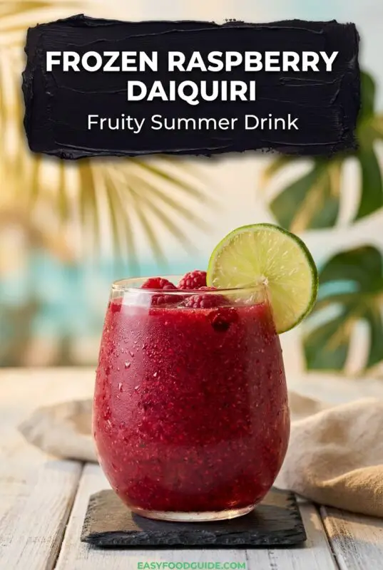 A glass of frozen raspberry daiquiri garnished with a lime slice and fresh raspberries, set against a tropical background with text overlay 'Frozen Raspberry Daiquiri Fruity Summer Drink'