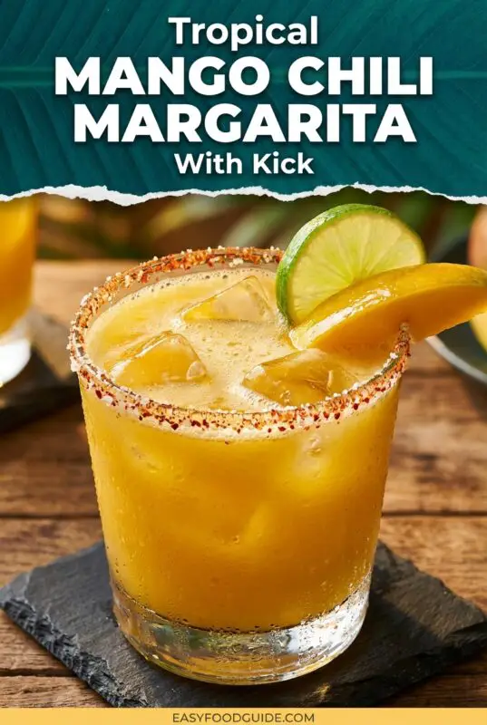 A refreshing Mango Chili Margarita with a chili salt rim, garnished with lime and mango slices.