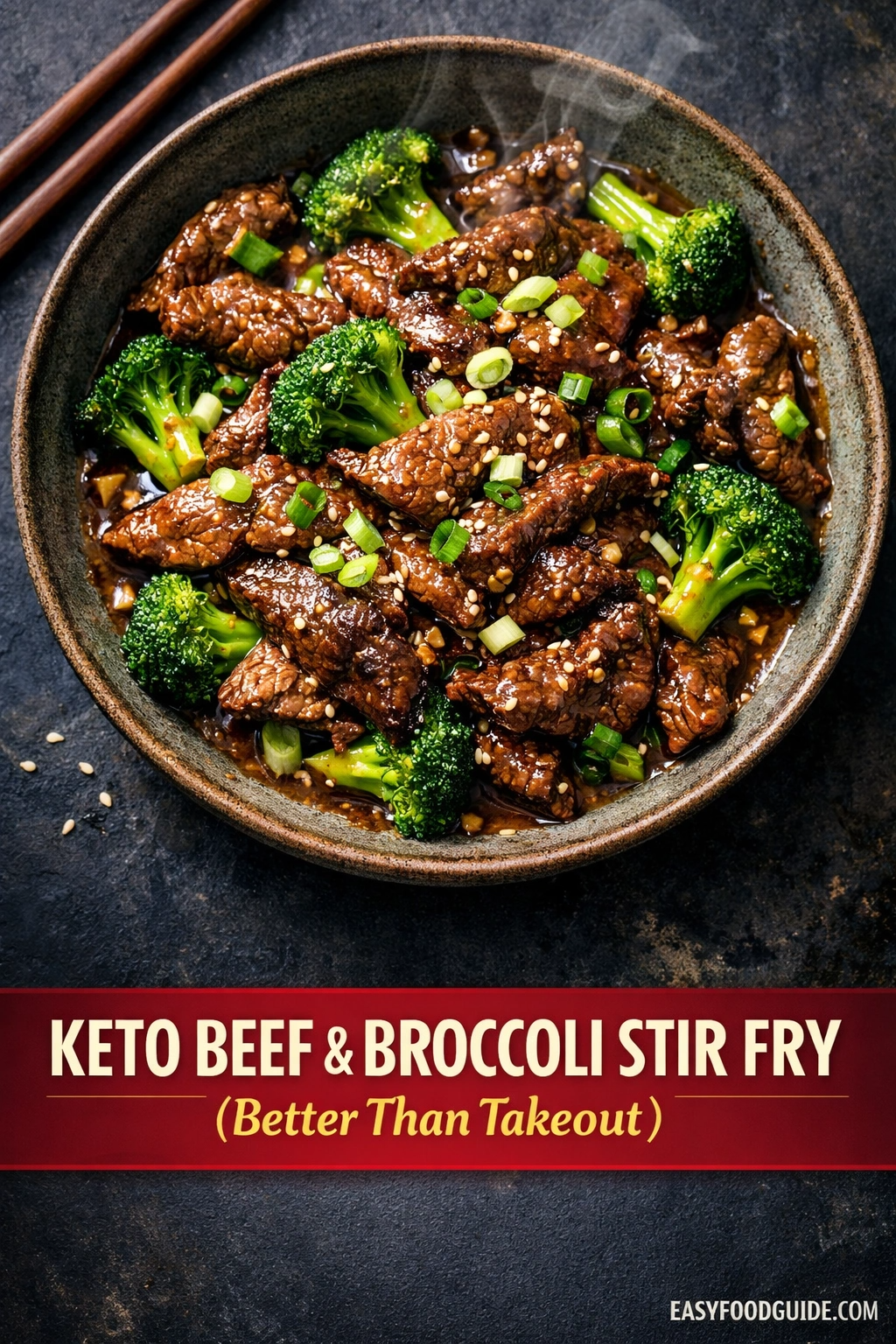 a top-down view of a bowl filled with a Keto beef and broccoli stir fry. The dish includes succulent pieces of beef coated in a glossy sauce, interspersed with vibrant green broccoli florets. Garnishes of chopped spring onions and sesame seeds are sprinkled on top, adding texture and color contrast. The bowl is placed on a dark, textured surface with a pair of wooden chopsticks resting beside it. Below the bowl, a red banner with white and yellow text advertises the dish.