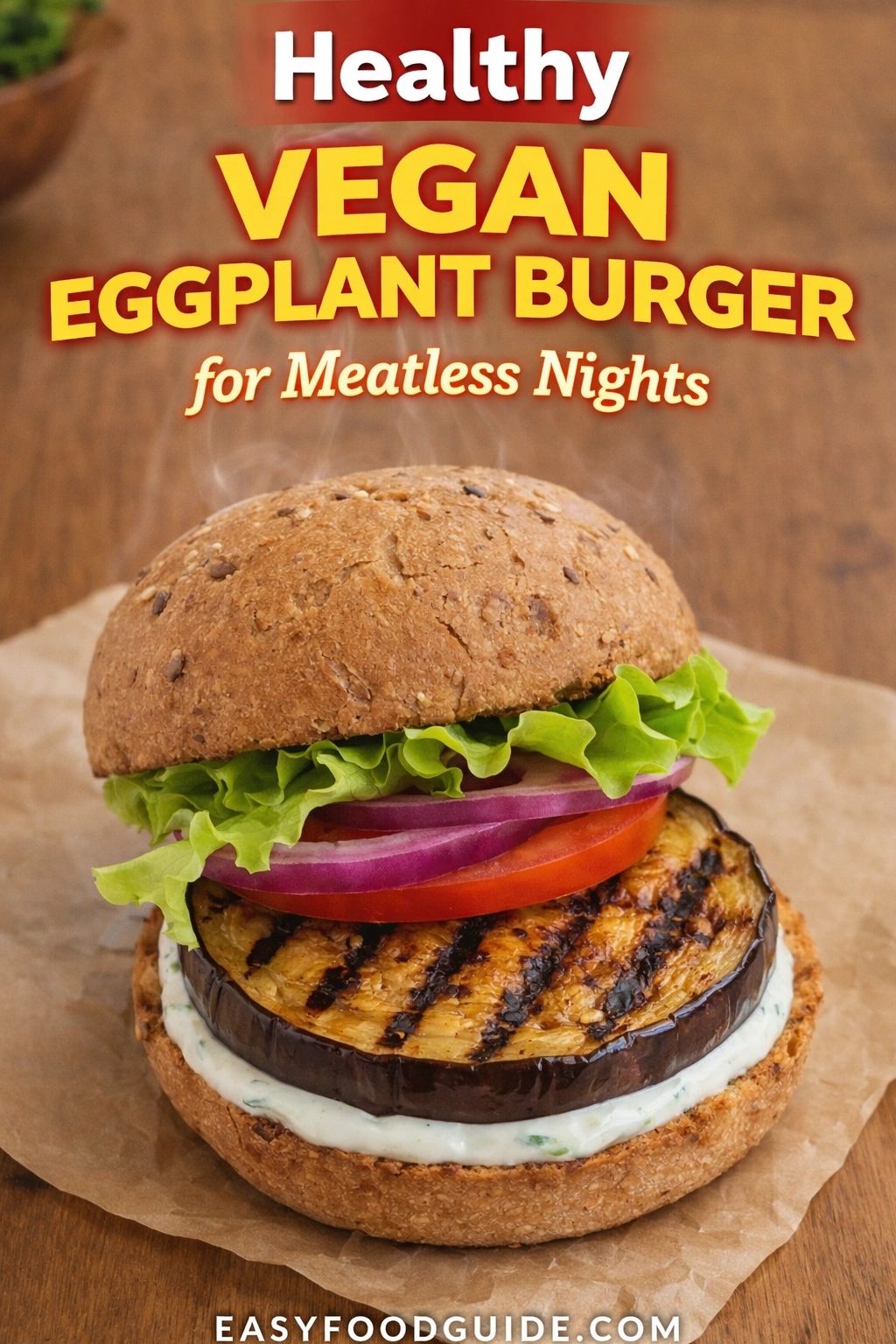 A healthy vegan eggplant burger, perfect for meatless nights. The grilled eggplant patty is served on a whole-grain bun with lettuce, tomato, red onion, and a creamy sauce. Text reads "Healthy VEGAN EGGPLANT BURGER for Meatless Nights," and the website "EASYFOODGUIDE.COM" is at the bottom.