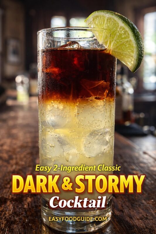 Easy 2-Ingredient Classic Dark & Stormy Cocktail: tall glass filled with ice, layered dark rum floating atop fizzy ginger beer, garnished with a fresh lime wedge. Condensation beads on the chilled glass; rustic bar background softly blurred. Text: “Easy 2-Ingredient Classic DARK & STORMY Cocktail” + EASYFOODGUIDE.COM. Refreshing, bold, and effortlessly elegant — perfect for summer sipping or tropical-themed gatherings.