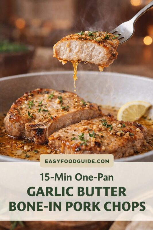 Fork lifts steaming, juicy slice of garlic butter pork chop — golden crust, tender interior, herbs and glistening sauce dripping. Below: two bone-in chops in skillet with lemon wedge, minced garlic, thyme, and rosemary. Warm bokeh background. Text overlay: “EASYFOODGUIDE.COM” above “15-Min One-Pan GARLIC BUTTER BONE-IN PORK CHOPS” in green on cream banner. Inviting, rustic lighting.