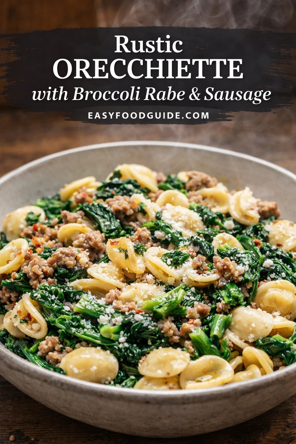 Rustic orecchiette pasta with broccoli rabe and sausage in a beige ceramic bowl. Small ear-shaped pasta mixed with dark green leafy vegetables, crumbled brown sausage, and white grated cheese. Steam rises from the hot dish. Text overlay reads "Rustic ORECCHIETTE with Broccoli Rabe & Sausage" and "EASYFOODGUIDE.COM" on dark banner at top.